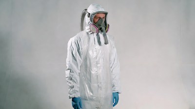 Man in white hazmat suit and respirator