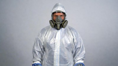 Man in hazmat suit with respirator