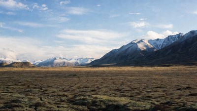 Snow-capped mountains over brown tundra