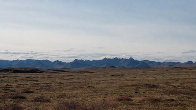Jagged Mountains Over Vast Tundra