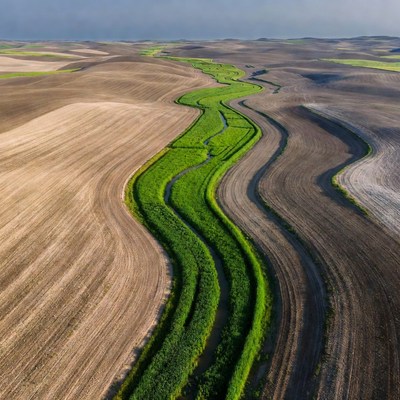 Aerial View of Winding Green River in Farmlands