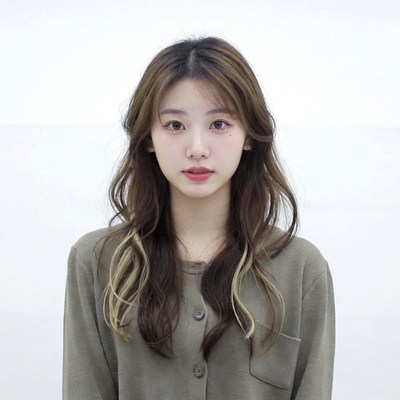 Asian woman in green sweater