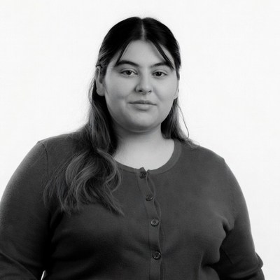 Latino woman in cardigan