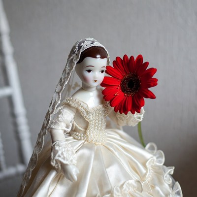 Porcelain Bride Doll Holding Red Gerbera