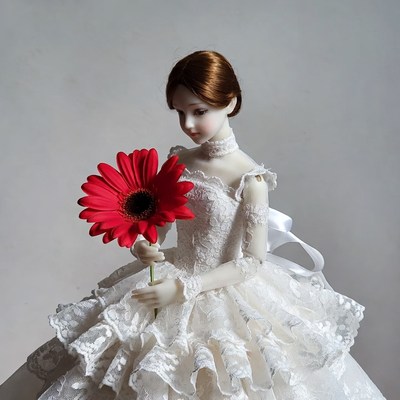 Doll holding red daisy