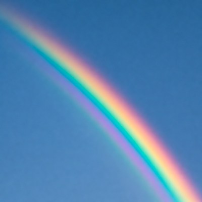 Vibrant Rainbow in Blue Sky