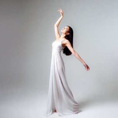 Asian woman dancing in white gown