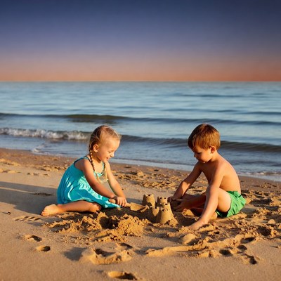 Boy and girl building sandcastle on beach