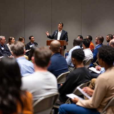 Man speaking at diverse business meeting