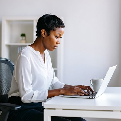 African-American woman typing on laptop