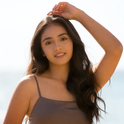 Young Asian woman hand on head beach