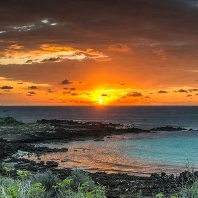 Sunset over rocky ocean shore
