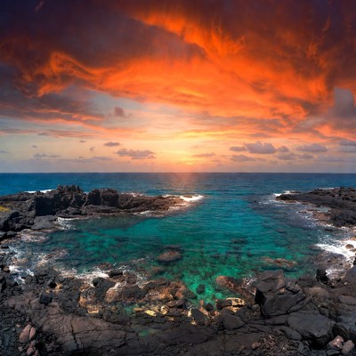 Dramatic Sunset Over Turquoise Ocean Rocks