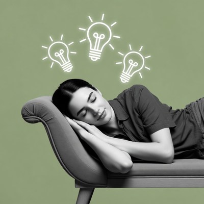Woman sleeping with idea lightbulbs