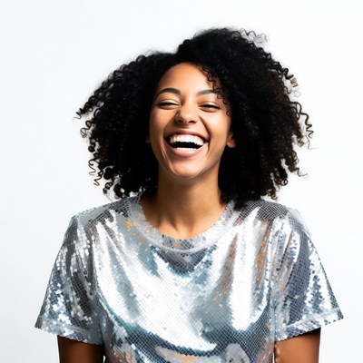 African-American woman laughing in sequin top