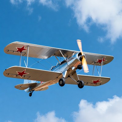 Silver Soviet Biplane Flying in Sky