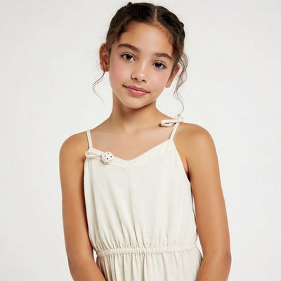 Young girl in white spaghetti strap dress