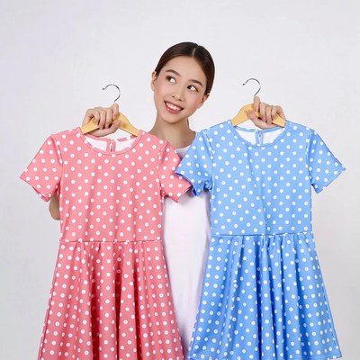 Asian woman holding pink blue polka dot dresses