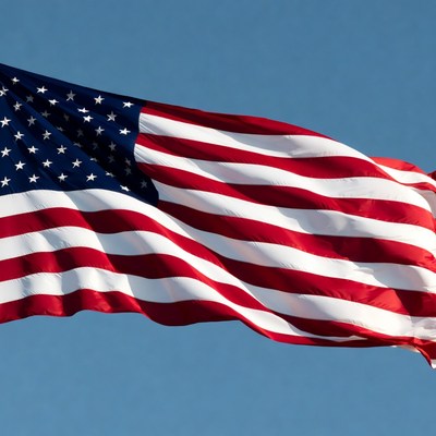 American flag waving against blue sky