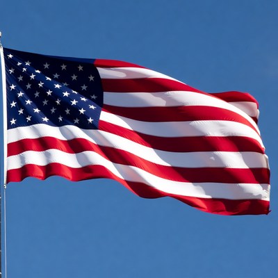 American flag waving against blue sky