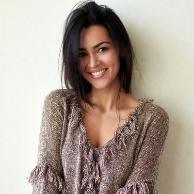 Smiling woman in fringed sweater
