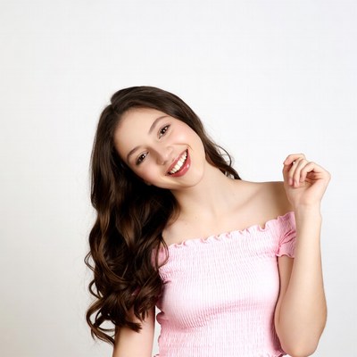 Smiling girl in pink off-shoulder top