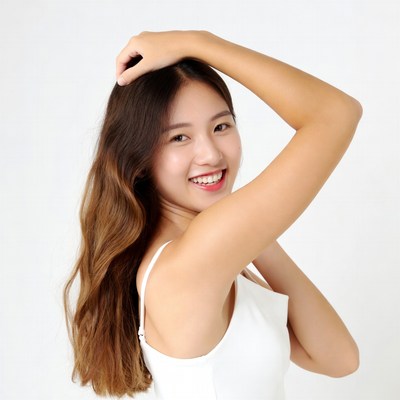 Asian woman smiling with hand in hair