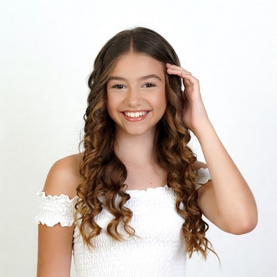 Smiling girl with hand on head