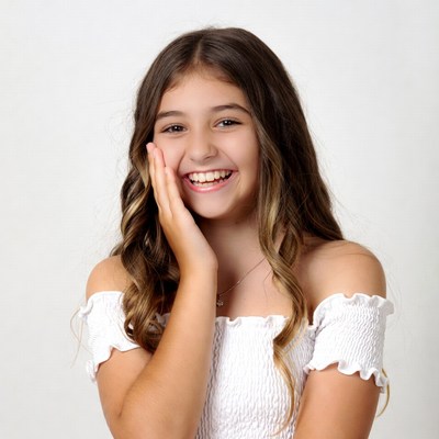 Smiling girl touching cheek