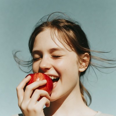 Girl biting red apple