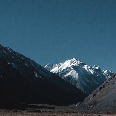 Snowy Mountain Peaks in Valley