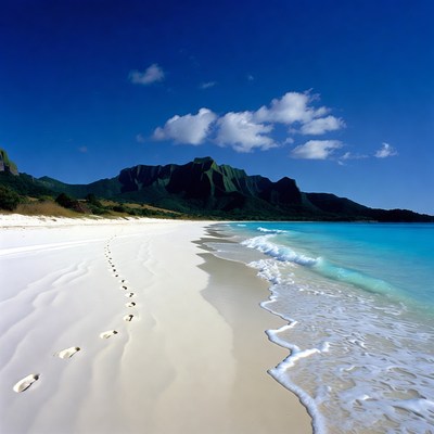 Footprints on white sand beach