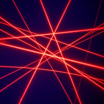 Red laser beams on dark background