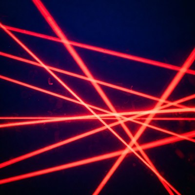Red laser beams on black background