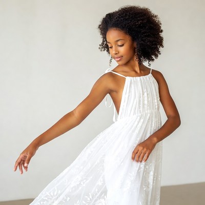 African-American girl dancing in white dress