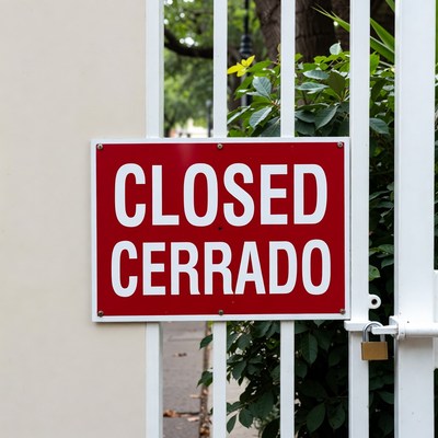 Closed Sign on White Gate