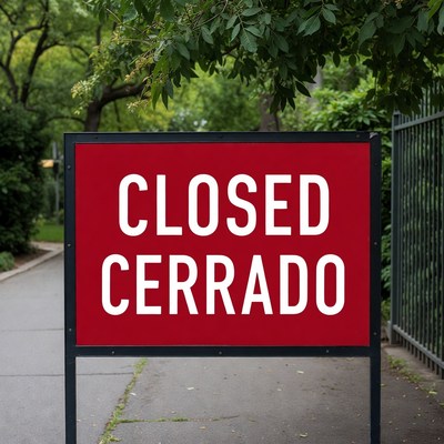 Closed Sign on Red Board by Fence