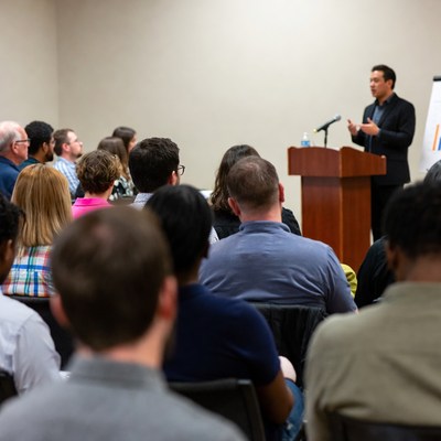 Asian man speaking at conference