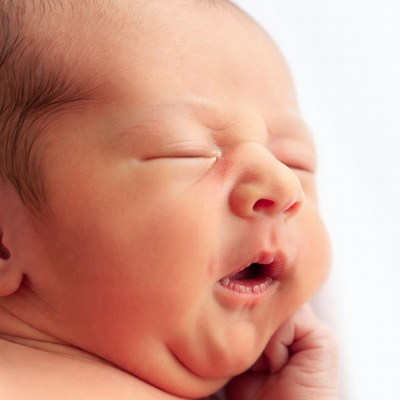 Newborn baby yawning closeup