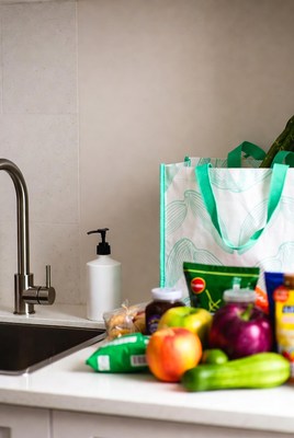 Grocery bag with vegetables on kitchen counter