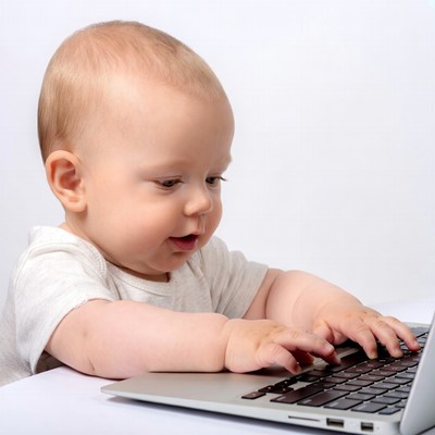 Baby typing on laptop
