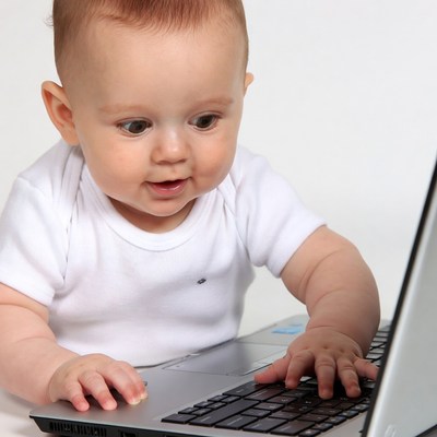 Baby typing on laptop