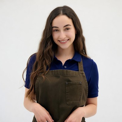 Smiling woman in navy polo and apron