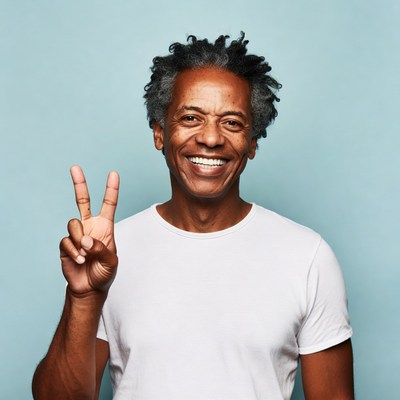 Smiling African-American man making peace sign