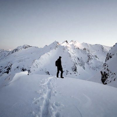 Man standing on snowy mountain ridge
