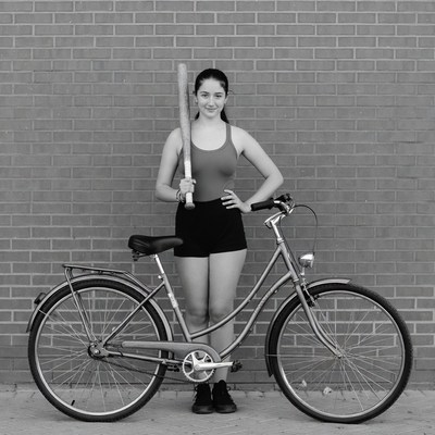 Woman with bat and bicycle