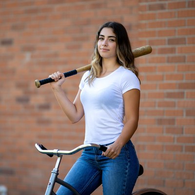 Woman with bat on bicycle