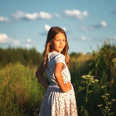 Girl in white dress in field