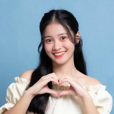 Asian woman making heart hands