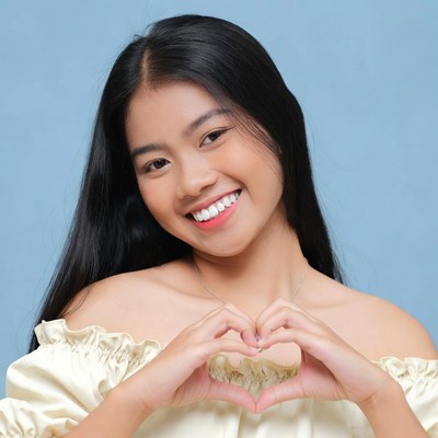 Asian girl making heart hands